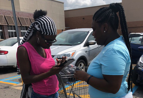 two Black women connecting in parking lot