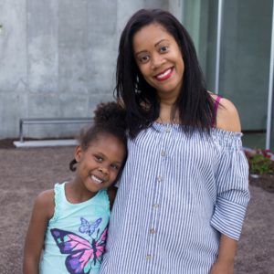 smiling Black woman with daughter