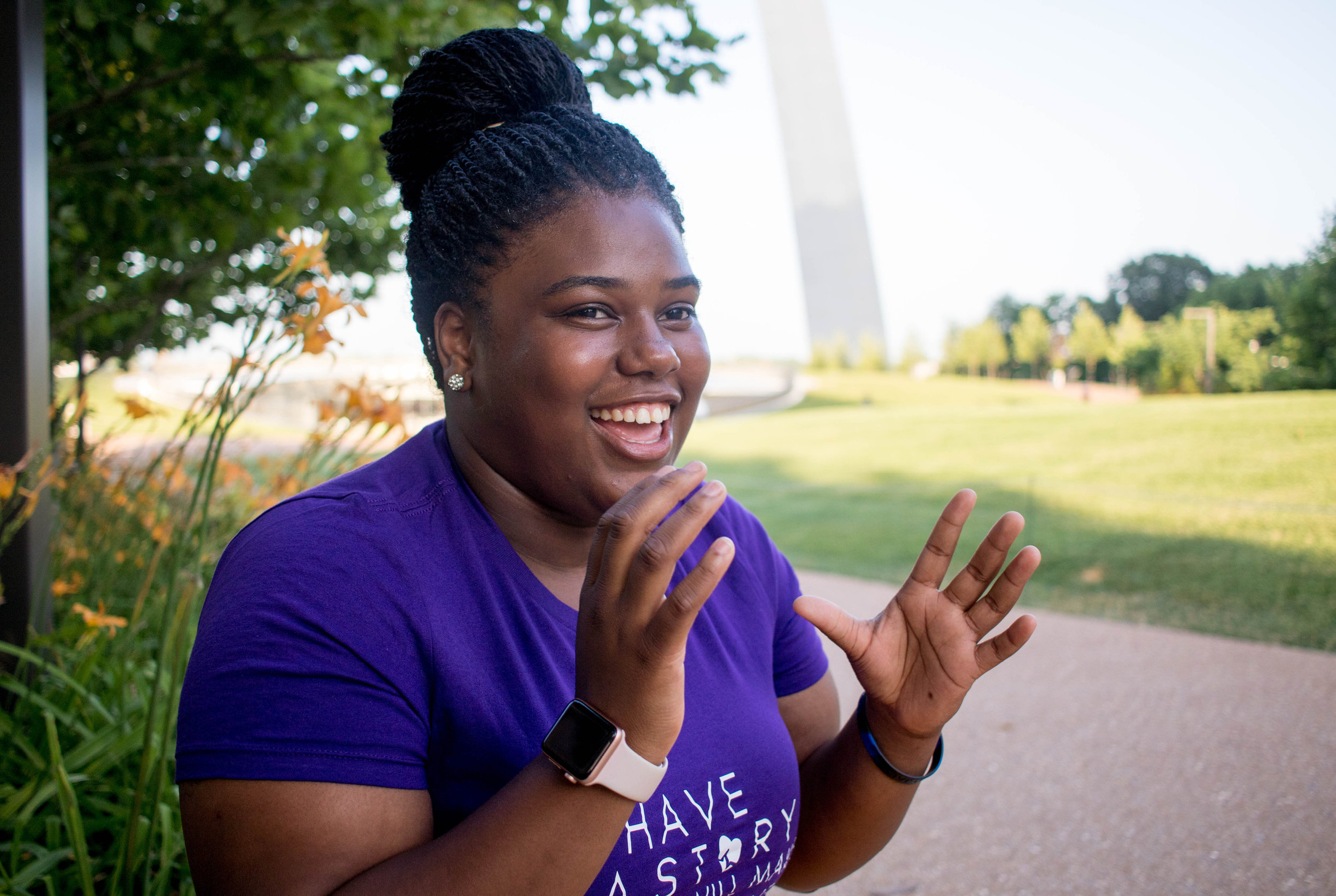 young Black woman laughing and gesturing with hands