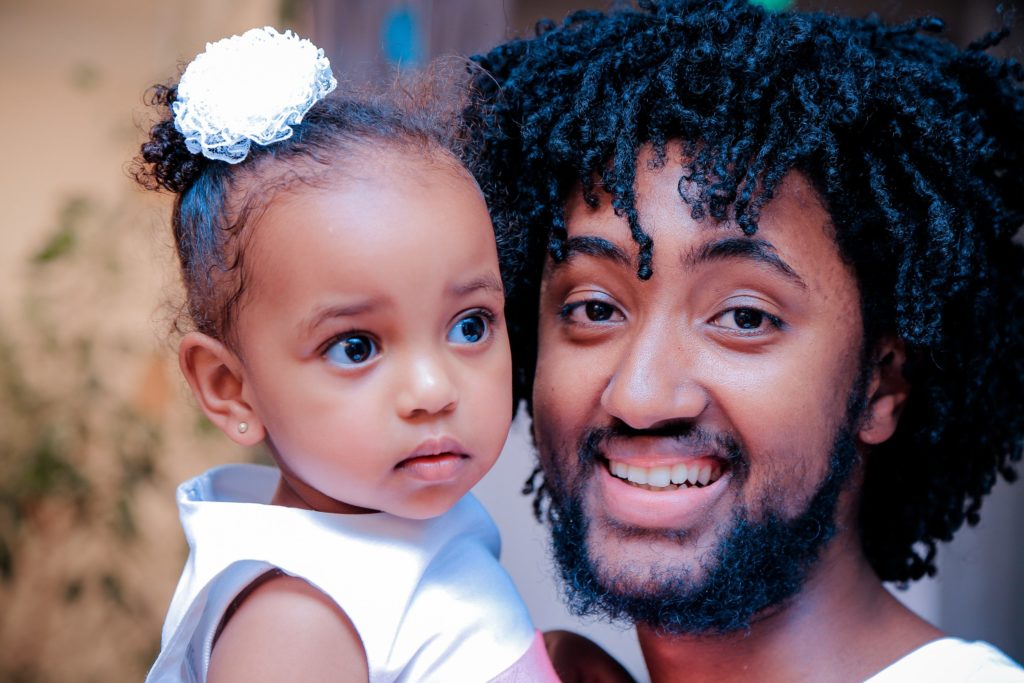 young Black man with daughter
