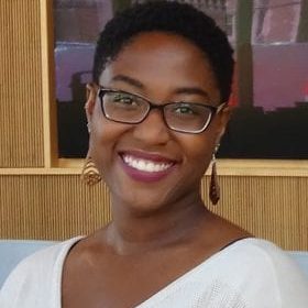 smiling Black woman with glasses and short hair
