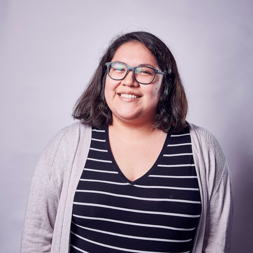 smiling young Latinx woman with glasses