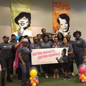 Group of smiling black women holding Better Budgets, Better Schools sign