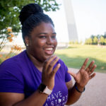 Laughing young black woman gesturing with hands