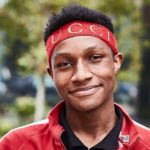Young smiling Black man wearing red headband