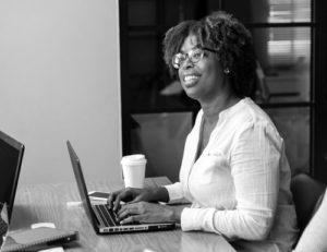 smiling black woman at laptop