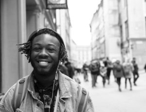 smiling young black man on city street